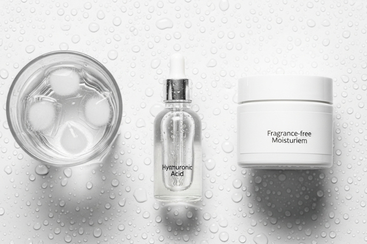 A clear hyaluronic acid serum bottle, and a fragrance-free moisturizer.