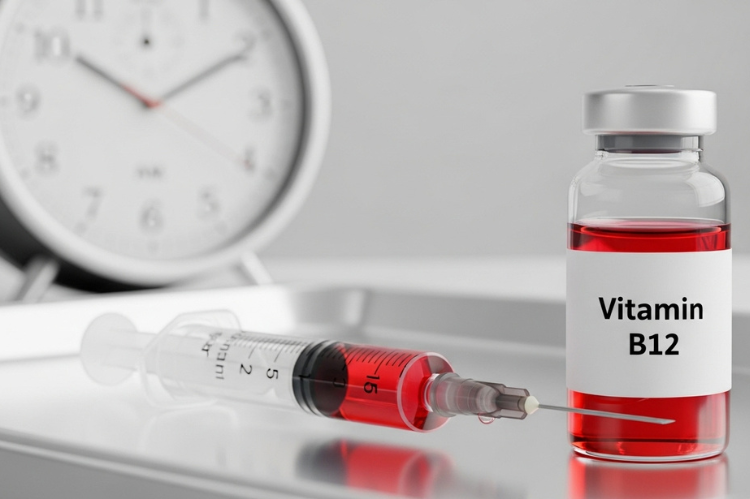 Vitamin B12 injection vial and syringe on a table, with a clock.